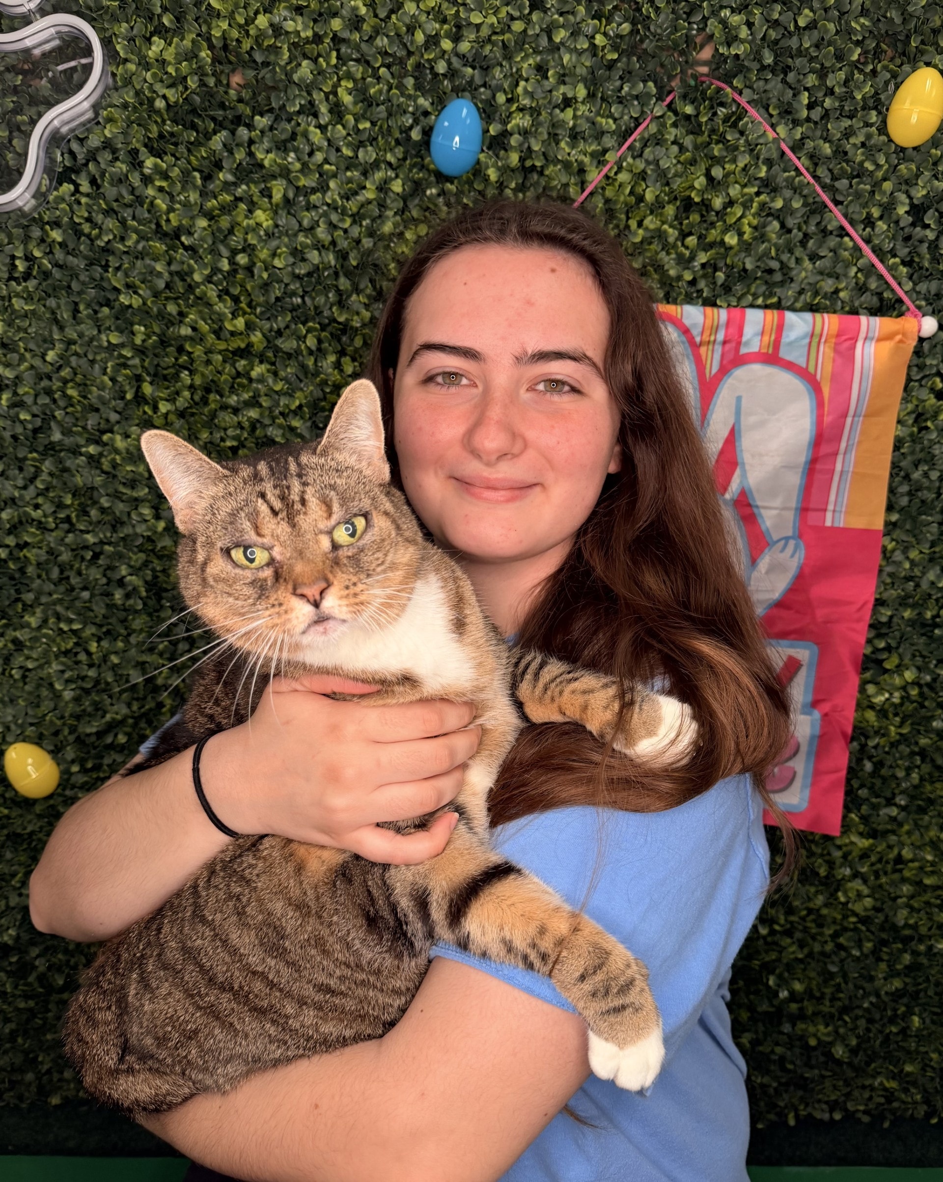 Caitlyn Clark, Foster Coordinator, holding a tabby cat.