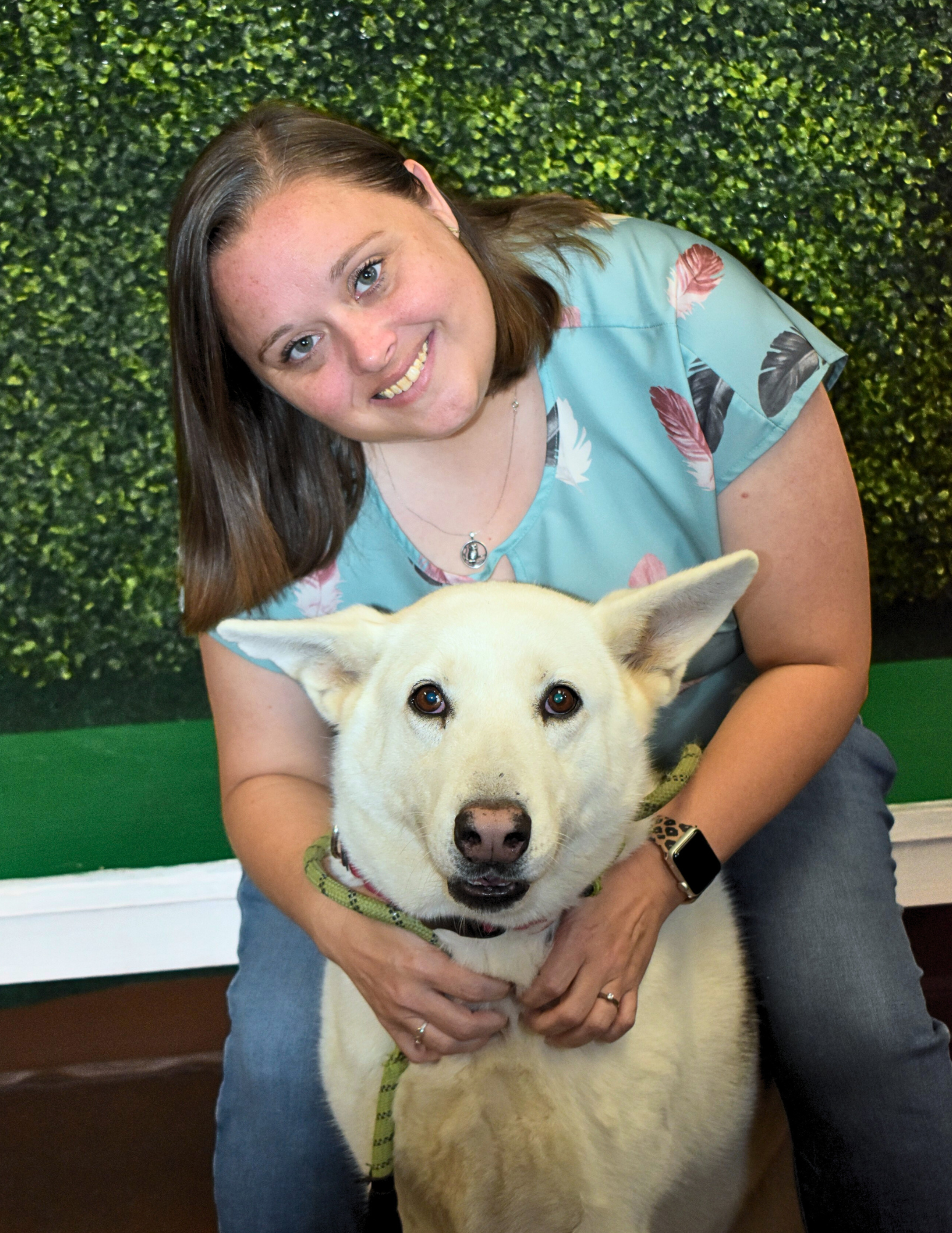 Aimee Pritchard, Outreach Coordinator, with a white dog.
