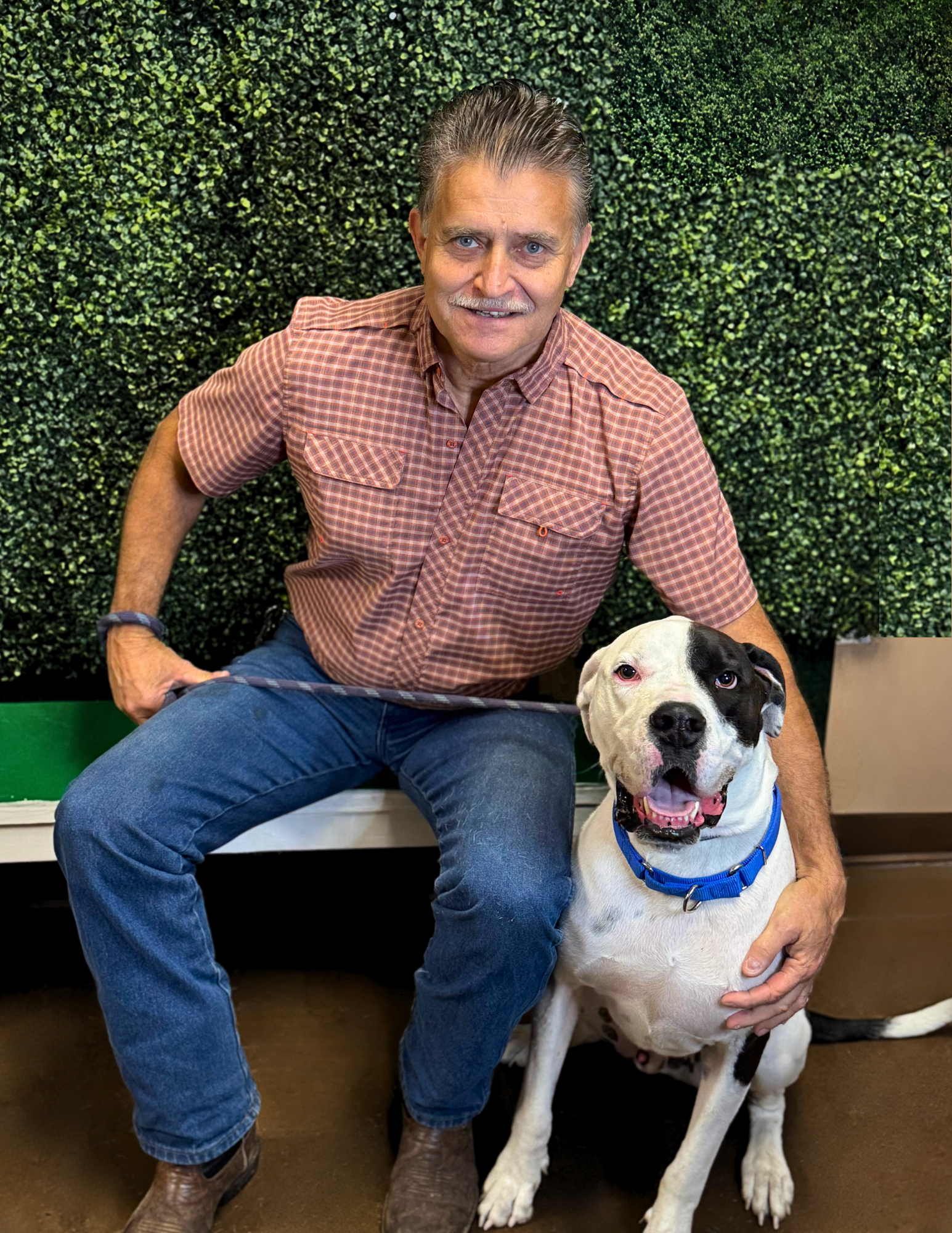 Eddie Leedy, Executive Director, with a dog.