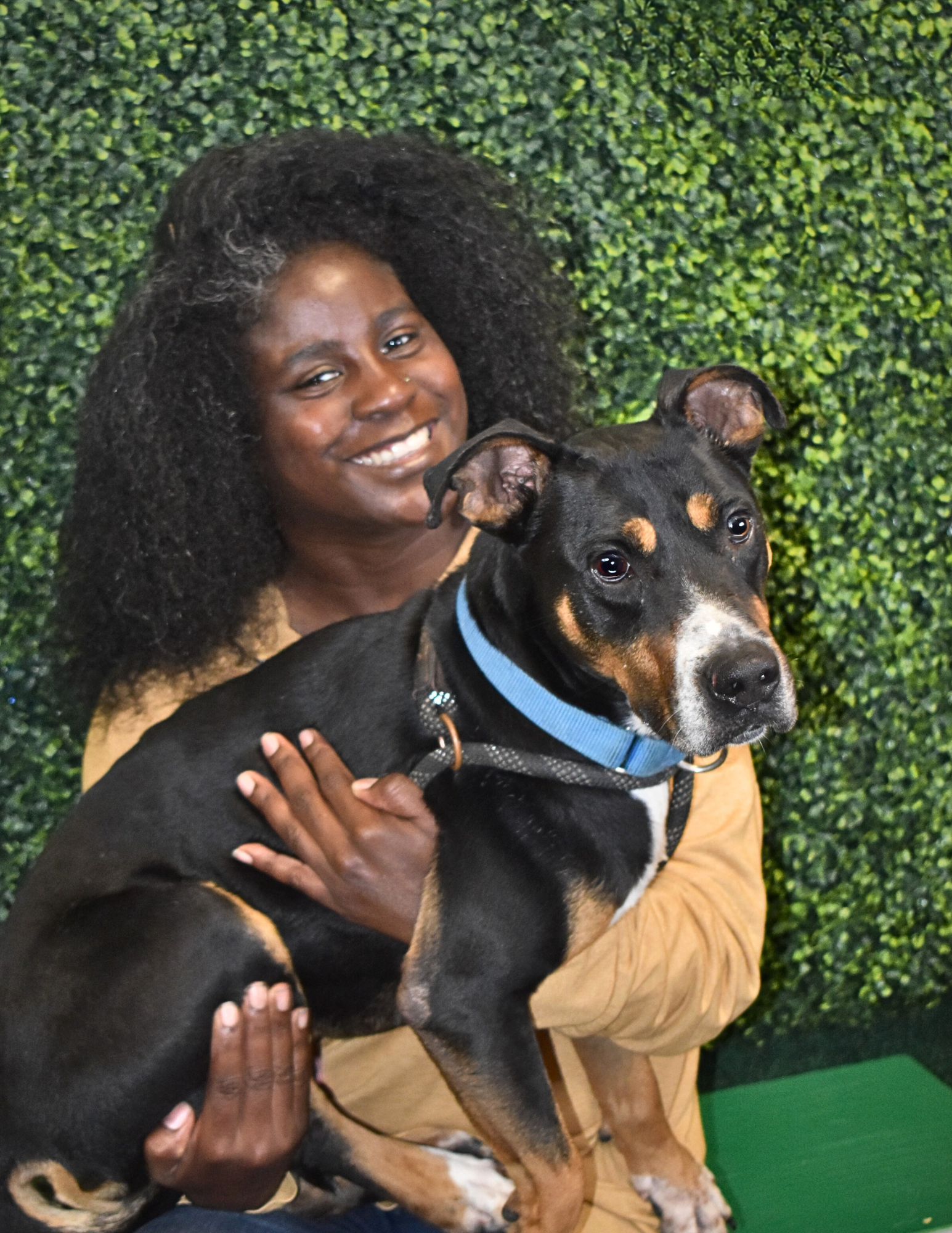 Fantasheia Williams, Lead Adoption Counselor, holding a dog.