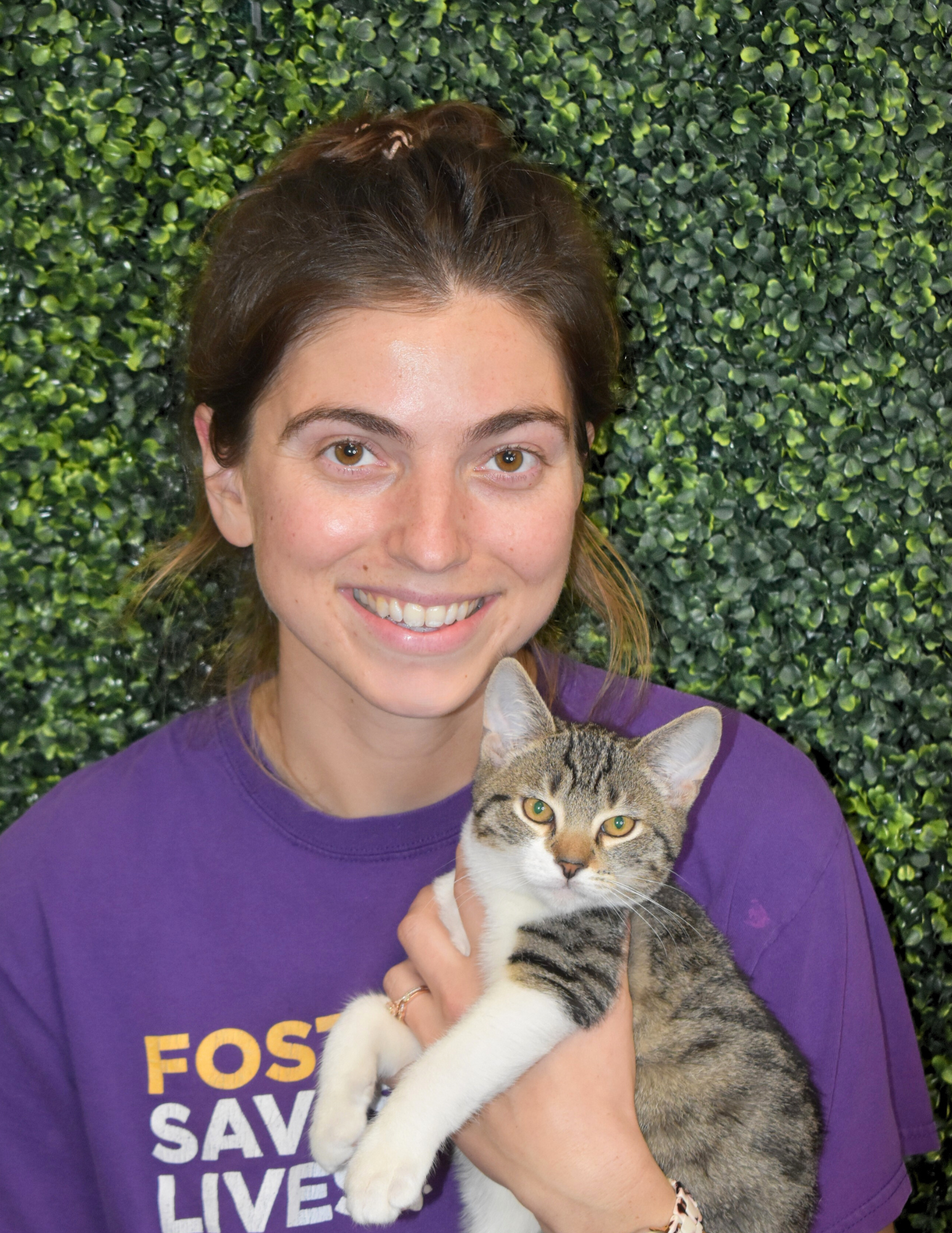 Madeline Sobel, Feline Care Coordinator, holding a kitten.