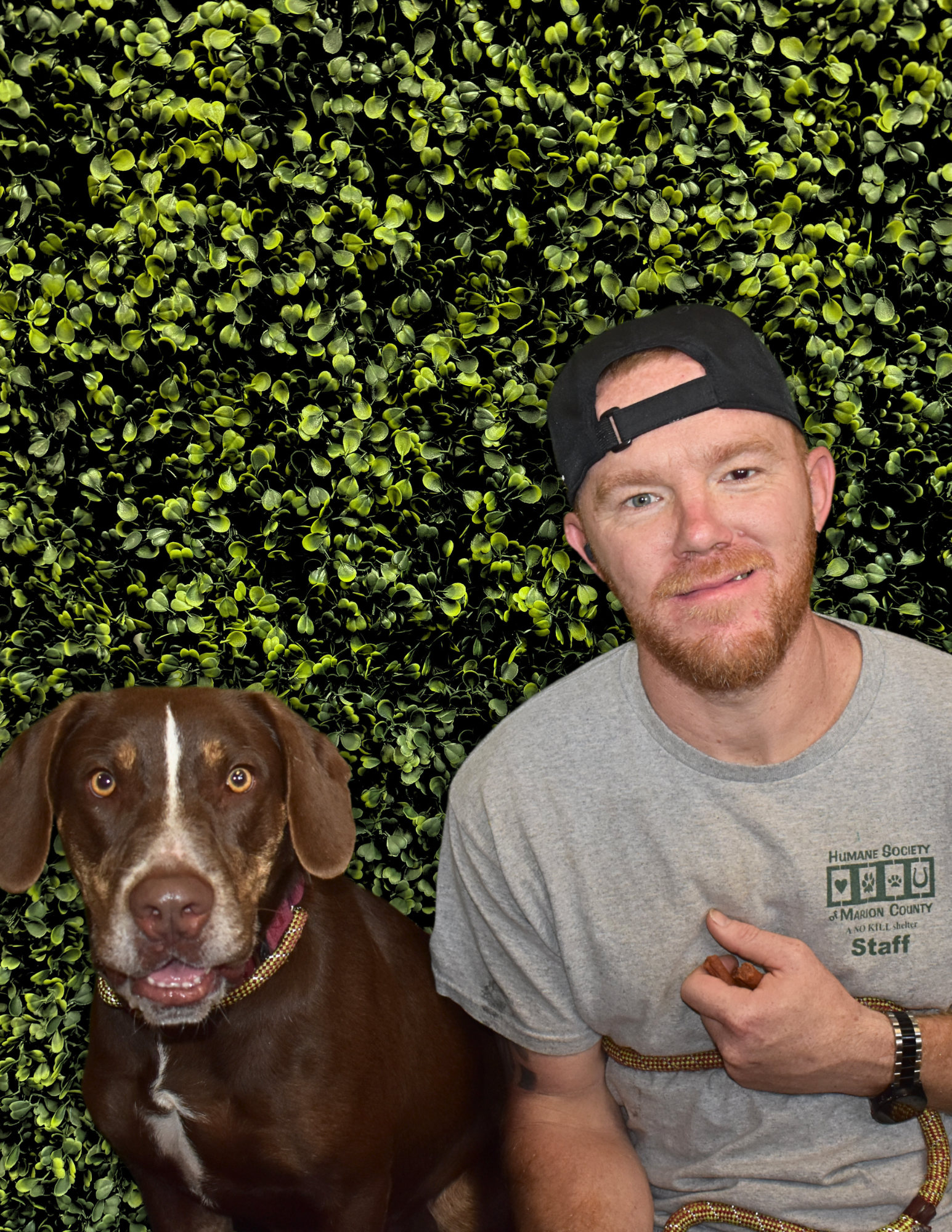 Ryan Fulford, Canine Adoption Manager, with a chocolate lab.
